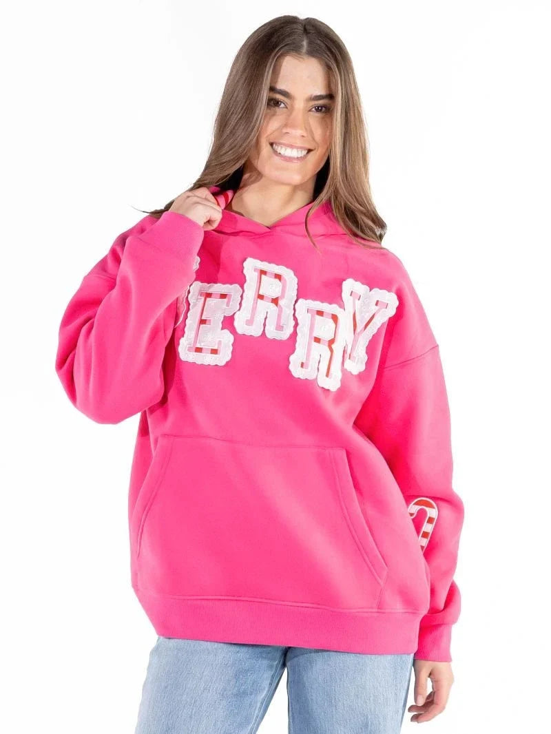 Woman wearing hot pink Simply Southern Merry appliqué hoodie with candy cane details at ooh la la! in Grapevine TX 76051