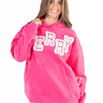 Woman wearing hot pink Simply Southern Merry appliqué hoodie with candy cane details at ooh la la! in Grapevine TX 76051
