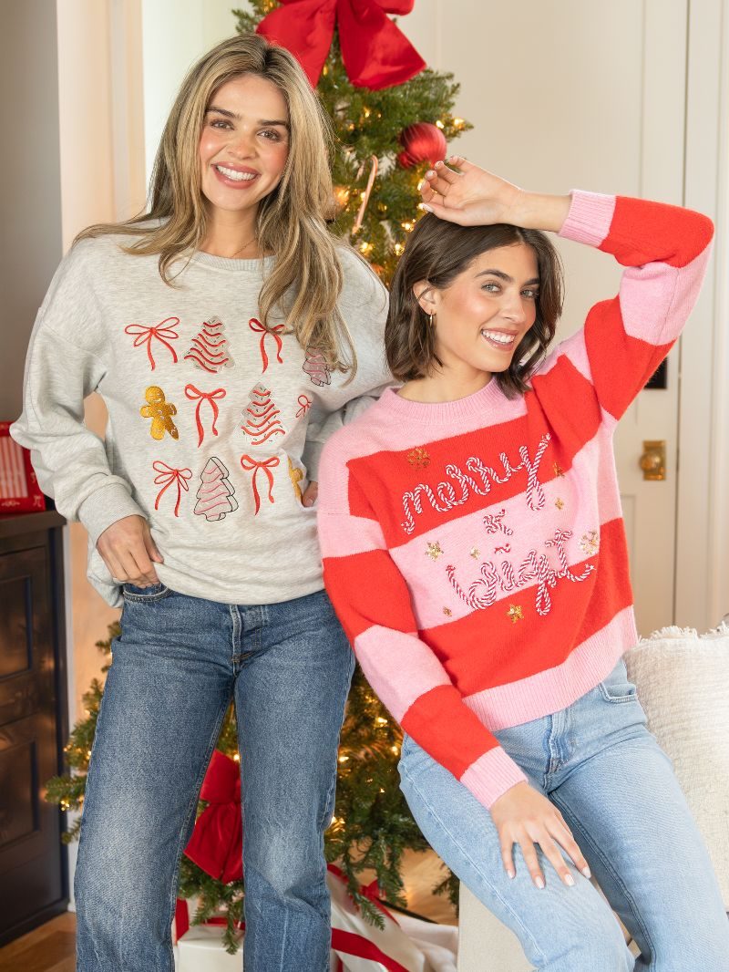 Merry and Bright embroidered red and pink striped pullover sweater on smiling model