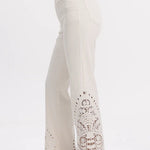 high rise straight jeans, paisley embroidery denim, cream cutout jeans, lyocell blend pants, bohemian straight leg, designer hem denim, white high waisted jeans at ooh la la! in Grapevine TX 76051