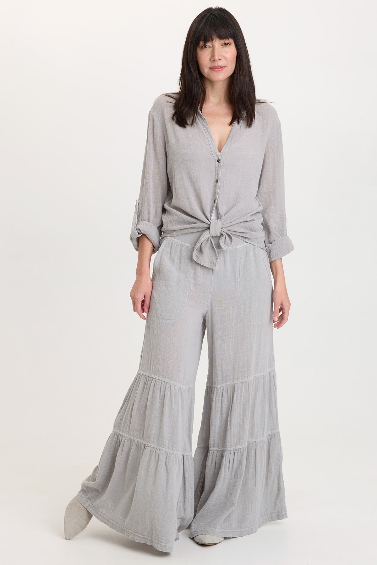 XCVI Lando Wide Leg Pants in soft pebble gray worn with matching tied blouse
