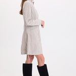 XCVI Uzma Corduroy Jacket Dress in Whitecap Pigment worn with black knee-high boots