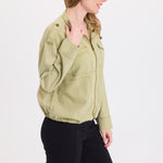 Woman wearing XCVI Tace Tencel Twill Relaxed Bomber Jacket in Artichoke Pigment with black pants