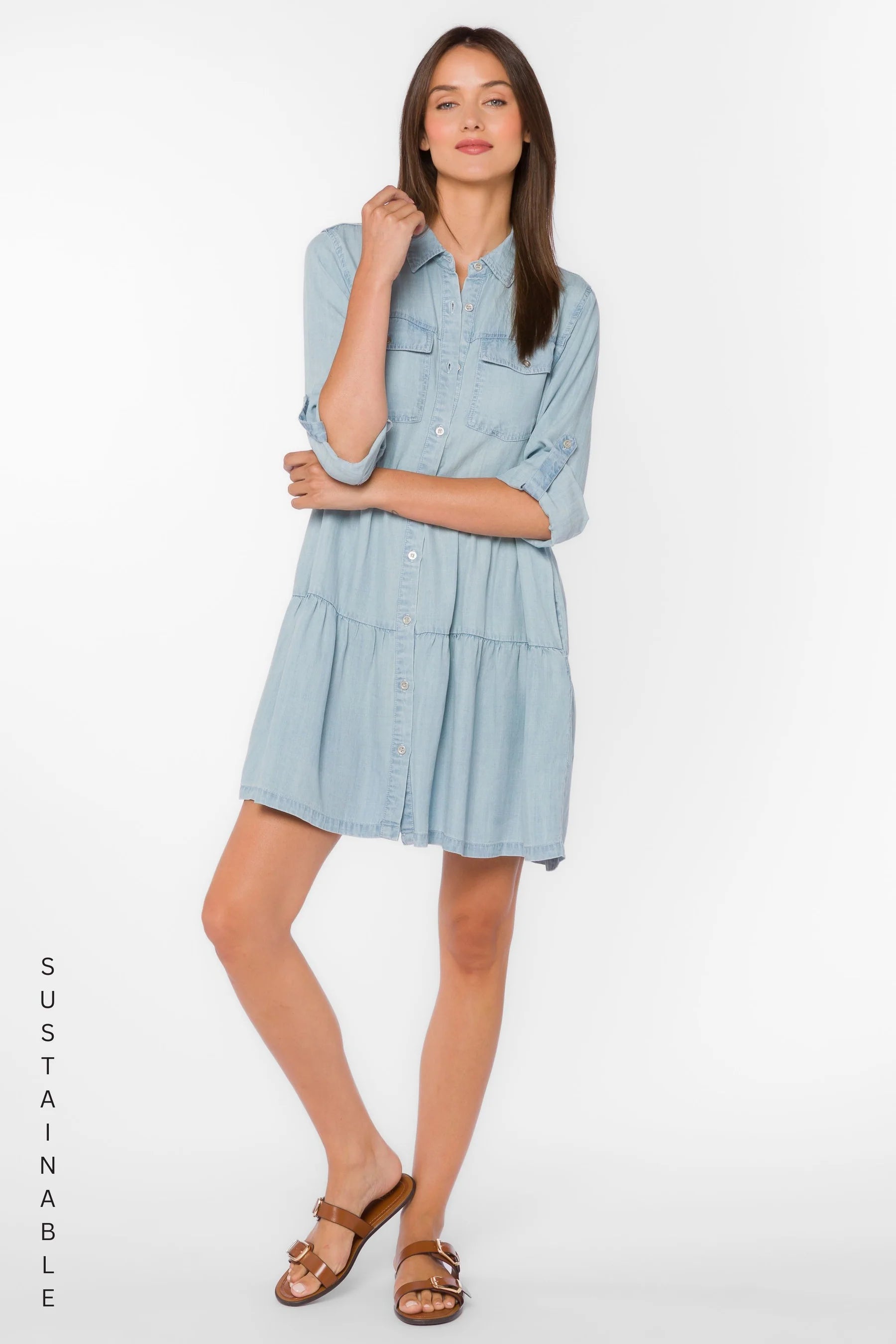 Bree Dress, Tencel lyocell dress, tiered mini dress, denim shirt dress, sustainable fashion, eco-friendly women's clothing, light blue chambray dress, tiered dress with pockets. at ooh la la! in Grapevine TX 76051