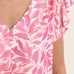 Flutter sleeve top, floral V-neck blouse, lightweight summer top, ruffled sleeve shirt, women’s botanical print top, pink floral blouse, breezy spring fashion. at ooh la la! in Grapevine TX 76051