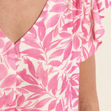 Flutter sleeve top, floral V-neck blouse, lightweight summer top, ruffled sleeve shirt, women’s botanical print top, pink floral blouse, breezy spring fashion. at ooh la la! in Grapevine TX 76051