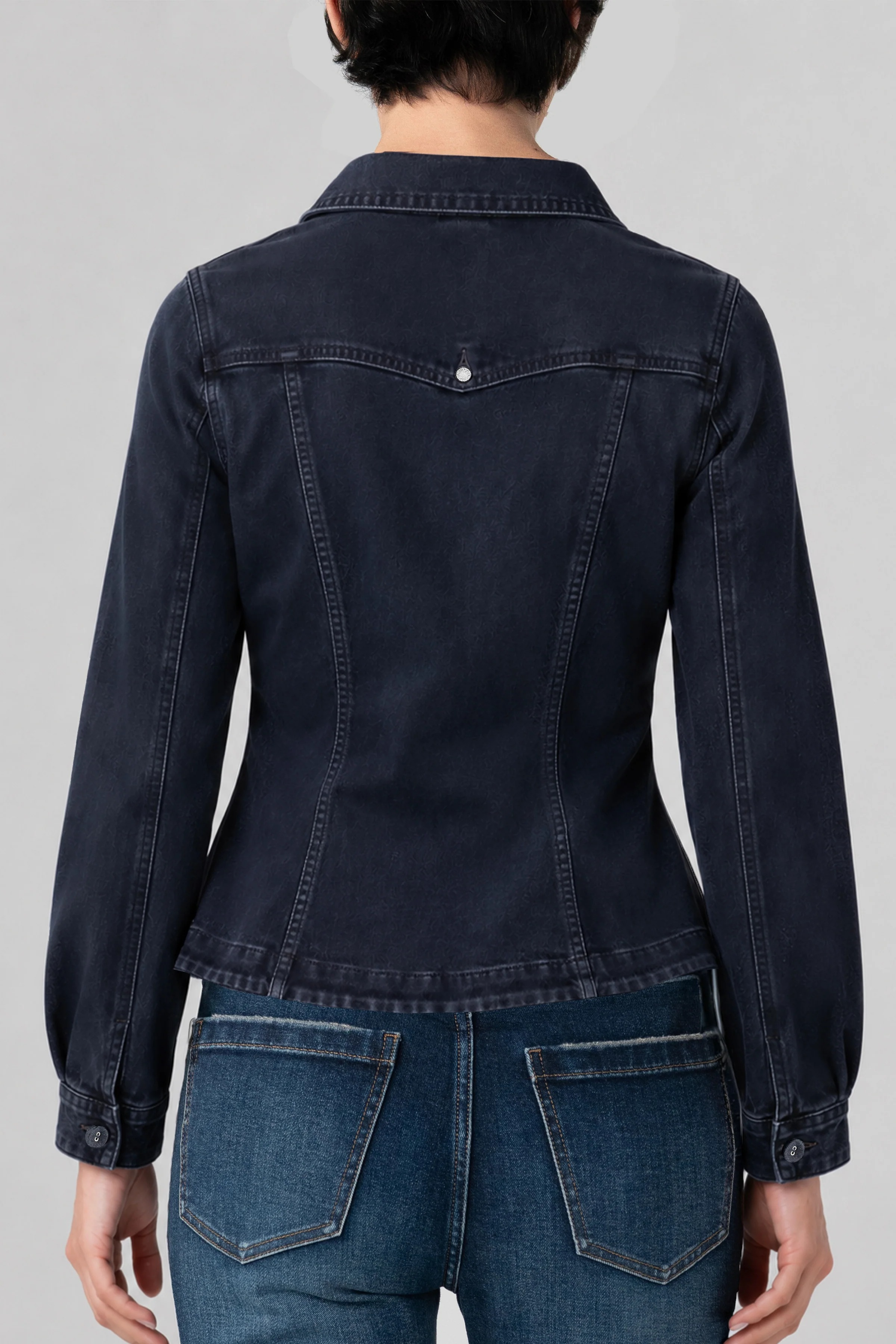 Back view of Liverpool fitted dark navy denim jacket with patch pockets on model