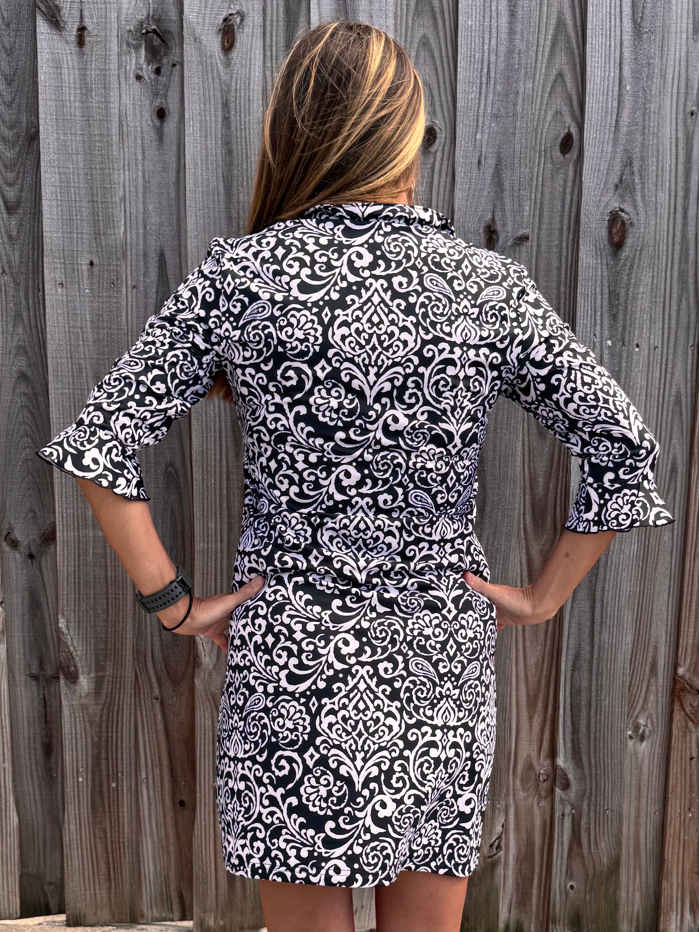 SPF 50 dress, polo dress for women, 3/4 sleeve flounce dress, sun protection clothing, summer golf dress, classy sporty dress, black and white paisley dress, gold button accents. at ooh la la! in Grapevine TX 76051
