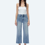 Model wearing high-rise wide-leg cropped jeans in light blue denim wash
