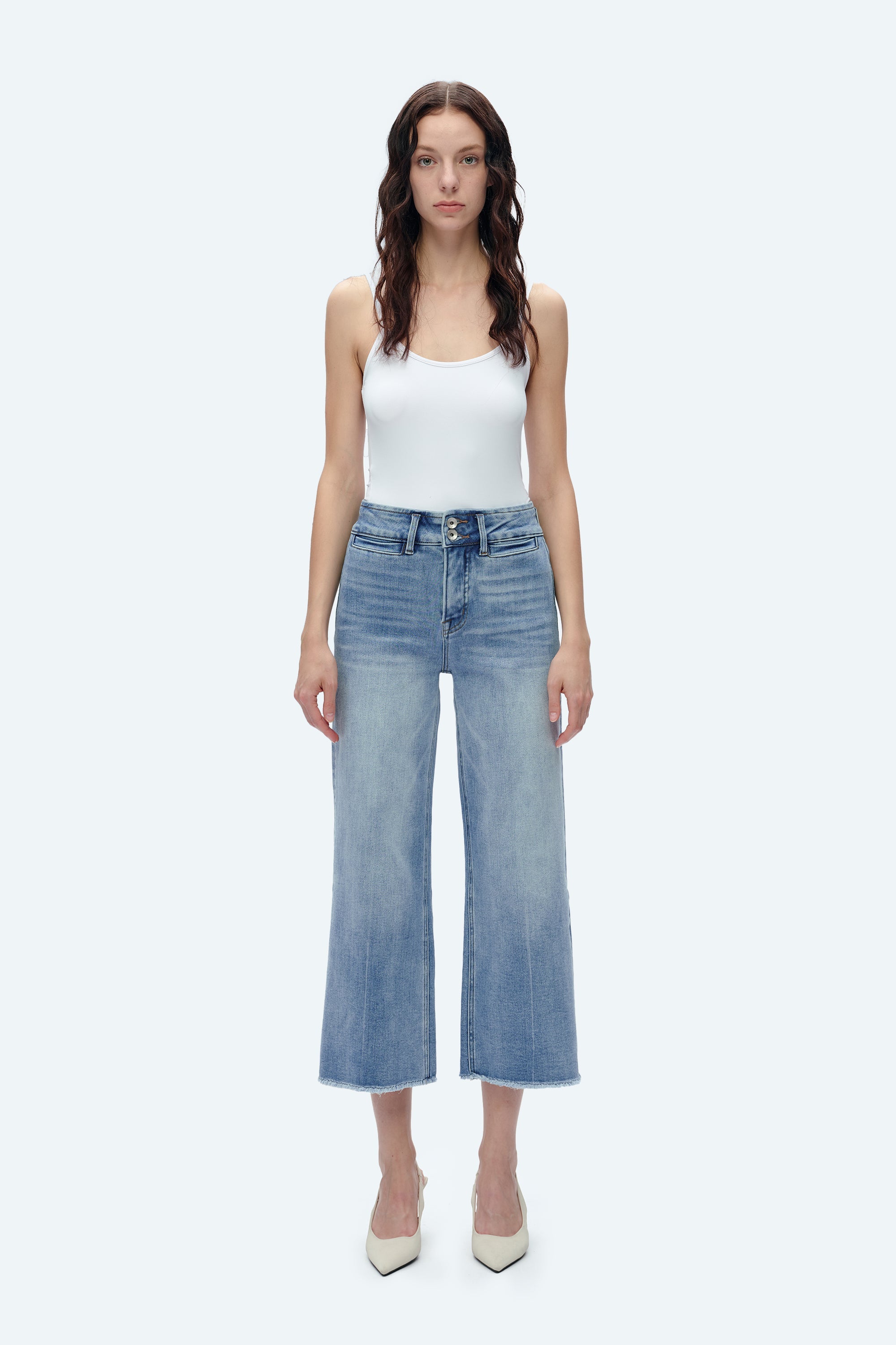 Model wearing high-rise wide-leg cropped jeans in light blue denim wash