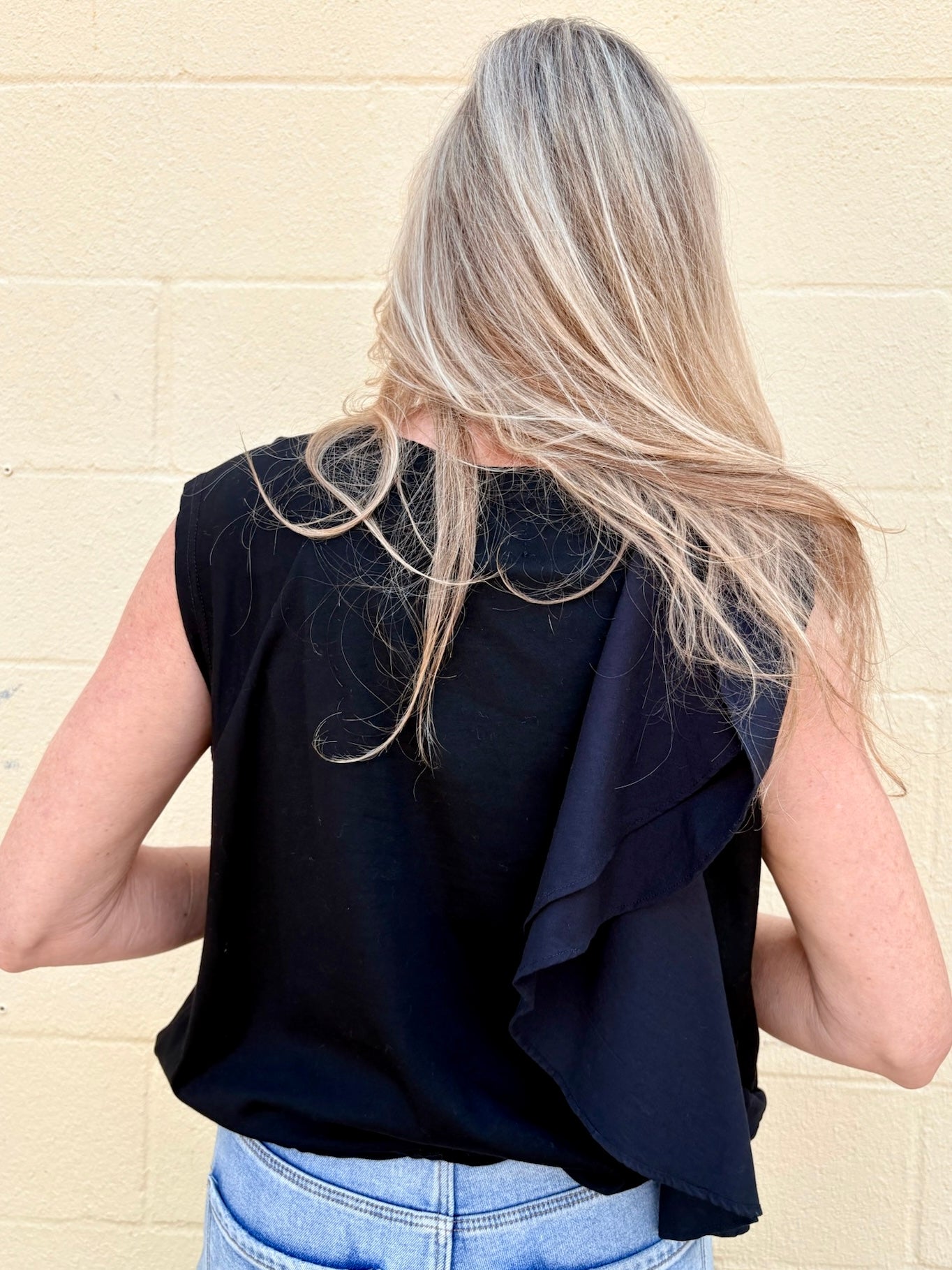 Black Asymmetrical top, ruffle crop top, sporty chic shirt, women's statement top, oversized cropped tee, streetwear fashion, architectural ruffle blouse.
at ooh la la! in Grapevine TX 76051