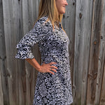 SPF 50 dress, polo dress for women, 3/4 sleeve flounce dress, sun protection clothing, summer golf dress, classy sporty dress, black and white paisley dress, gold button accents. at ooh la la! in Grapevine TX 76051