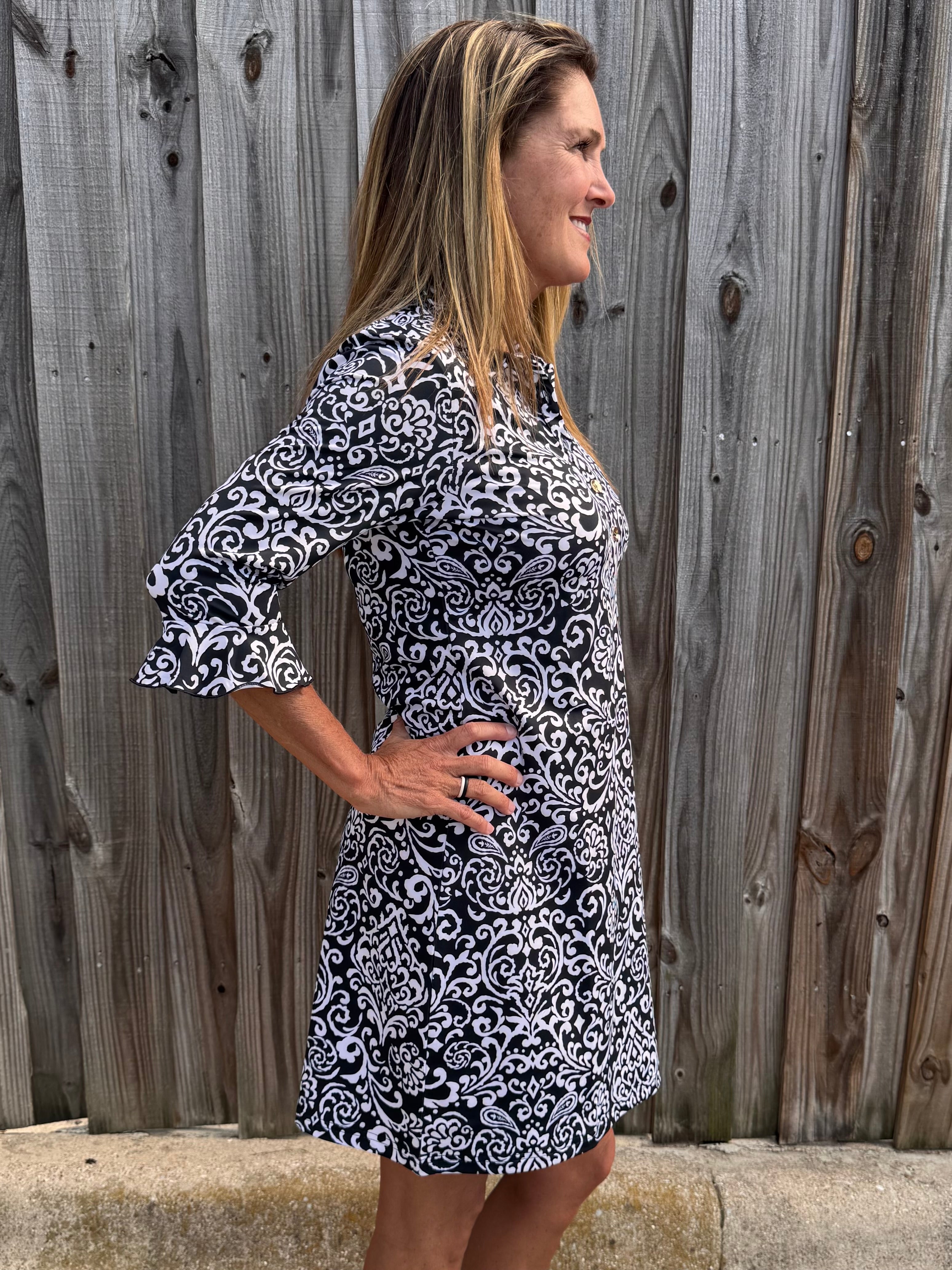 SPF 50 dress, polo dress for women, 3/4 sleeve flounce dress, sun protection clothing, summer golf dress, classy sporty dress, black and white paisley dress, gold button accents. at ooh la la! in Grapevine TX 76051