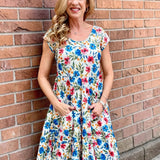 Dress Addict Jade dress, organic cotton floral dress, daisy print scoop neck, bias cut cotton dress, crinkle cotton summer dress, sustainable floral fashion, tiered skirt knee length dress at ooh la la! in Grapevine TX 76051