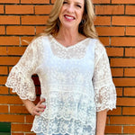 White Lace blouse, cotton boho top, bell sleeve shirt, floral embroidery top, scalloped hem blouse, feminine V-neck top, tiered lace top, bohemian fashion, white lace blouse, black vintage style top. at ooh la la! in Grapevine TX 76051