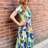 Dress Addict Jazy, organic cotton midi dress, multi color floral dress with pockets, sustainable summer dress, bias cut v-neck dress, women's tiered floral midi, travel-friendly crinkle dress. at ooh la la! in Grapevine TX 76051