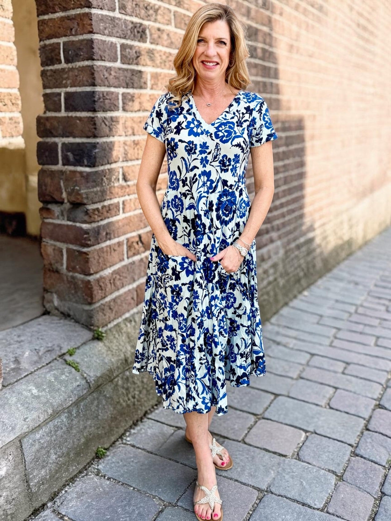Dress Addict Jazy, organic cotton midi dress, blue floral dress with pockets, sustainable summer dress, bias cut v-neck dress, women's tiered floral midi, travel-friendly crinkle dress. at ooh la la! in Grapevine TX 76051