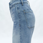 Light blue high-rise wide-leg cropped jeans on model against white background