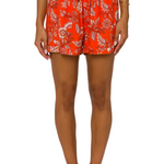 Orange floral shorts with drawstring waist on model against white background