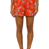 Orange floral shorts with drawstring waist on model against white background