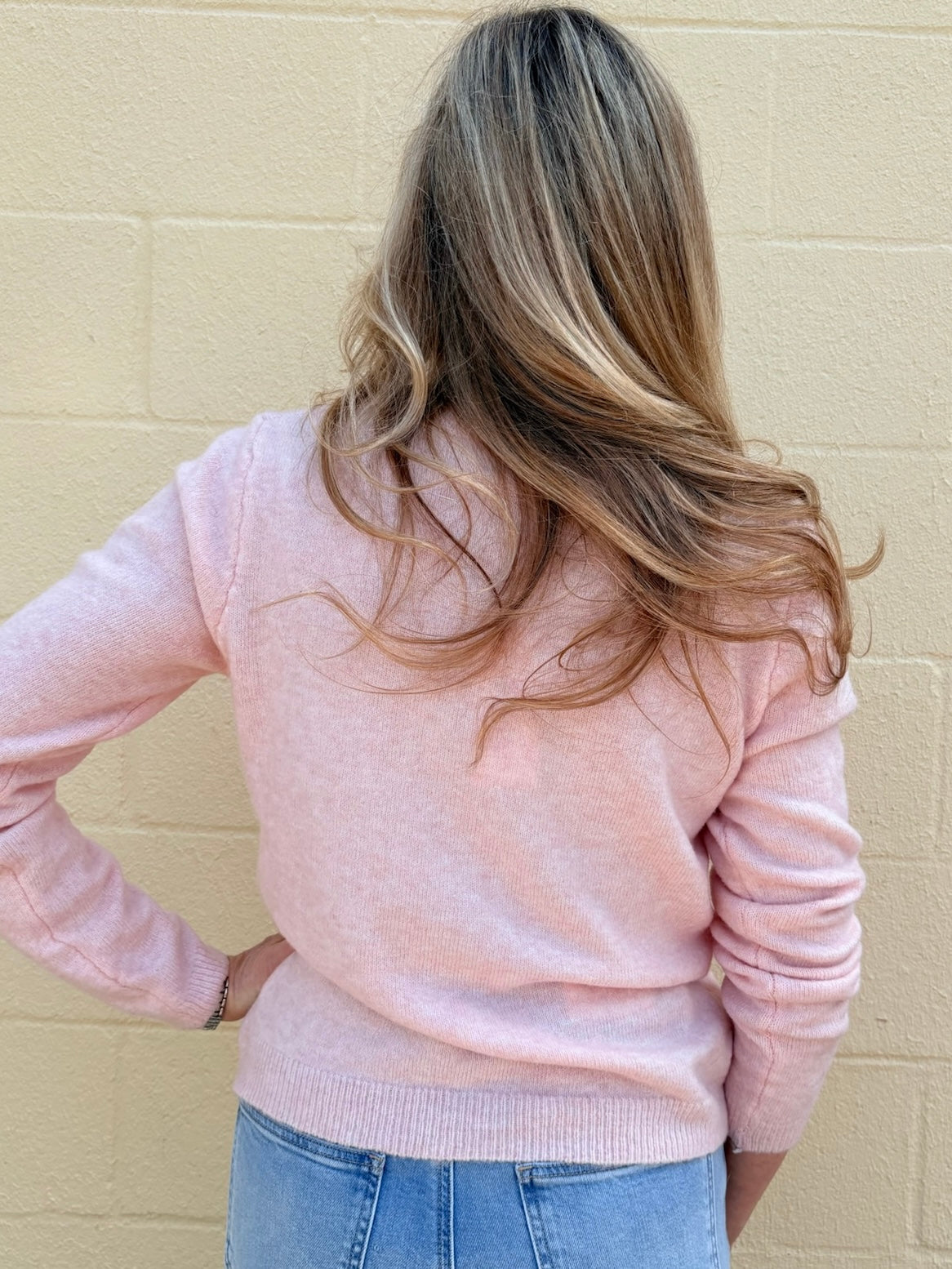 pink soft knit cardigan, women's crewneck cardigan, button down sweater, pastel knitwear, lightweight layering piece, classic women's sweater, pearl button cardigan, spring knitwear staples.
at ooh la la in Grapevine TX 76051