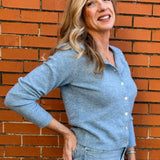 Light Blue soft knit cardigan, women's crewneck cardigan, button down sweater, pastel knitwear, lightweight layering piece, classic women's sweater, pearl button cardigan, spring knitwear staples.
at ooh la la in Grapevine TX 76051