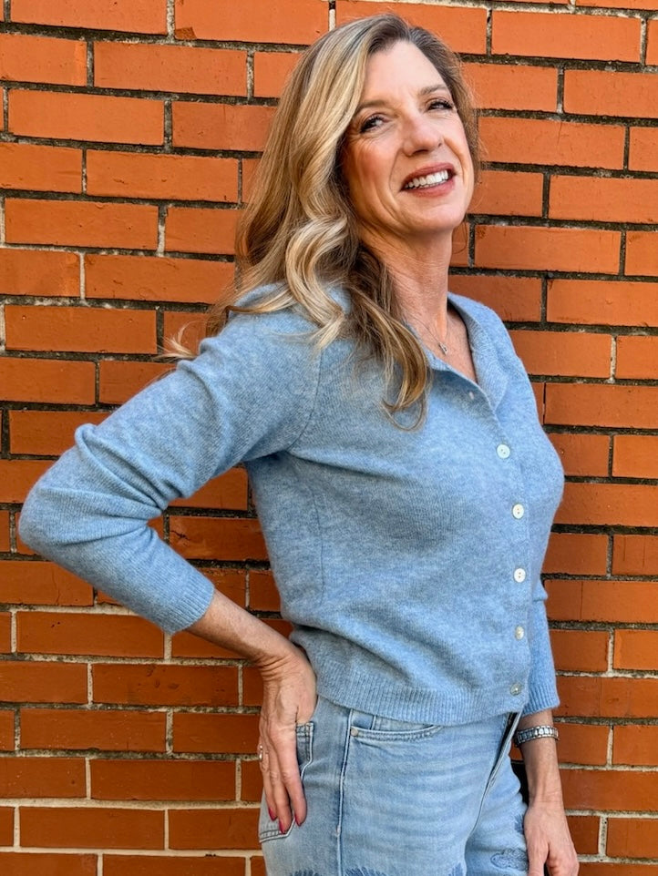 Light Blue soft knit cardigan, women's crewneck cardigan, button down sweater, pastel knitwear, lightweight layering piece, classic women's sweater, pearl button cardigan, spring knitwear staples.
at ooh la la in Grapevine TX 76051