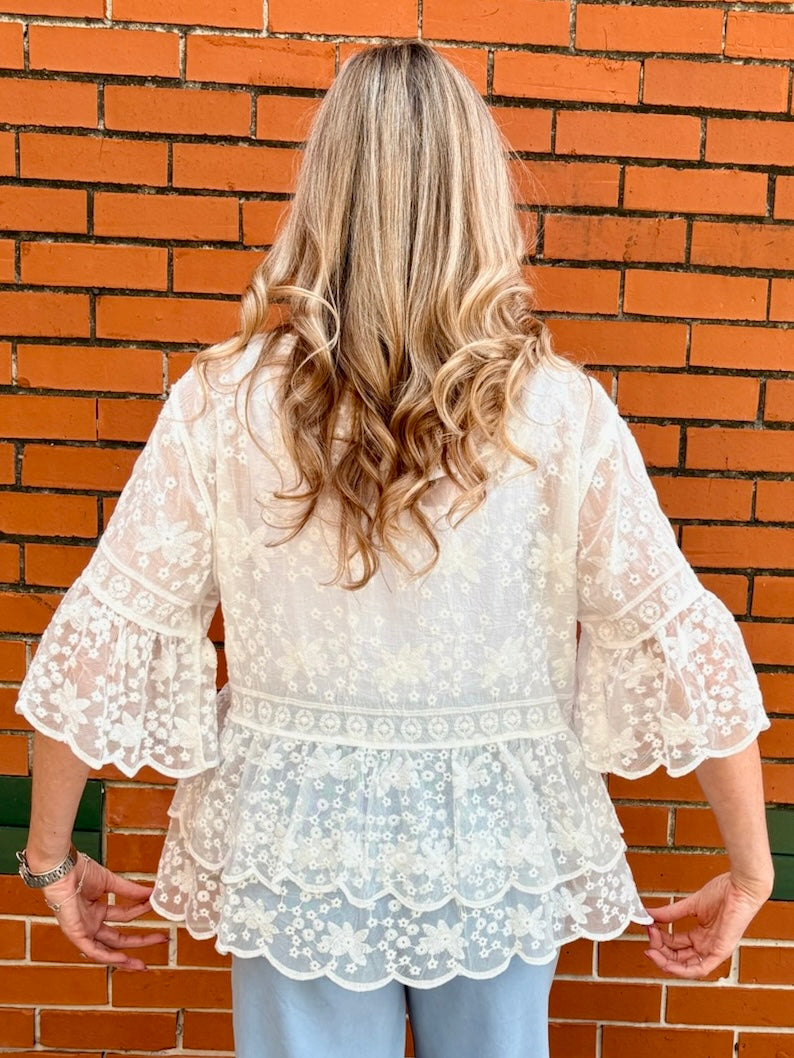 White Lace blouse, cotton boho top, bell sleeve shirt, floral embroidery top, scalloped hem blouse, feminine V-neck top, tiered lace top, bohemian fashion, white lace blouse, black vintage style top. at ooh la la! in Grapevine TX 76051
