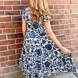 Dress Addict Jazy, organic cotton midi dress, blue floral dress with pockets, sustainable summer dress, bias cut v-neck dress, women's tiered floral midi, travel-friendly crinkle dress. at ooh la la! in Grapevine TX 76051