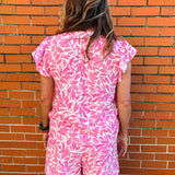 Flutter sleeve top, floral V-neck blouse, lightweight summer top, ruffled sleeve shirt, women’s botanical print top, pink floral blouse, breezy spring fashion. at ooh la la! in Grapevine TX 76051