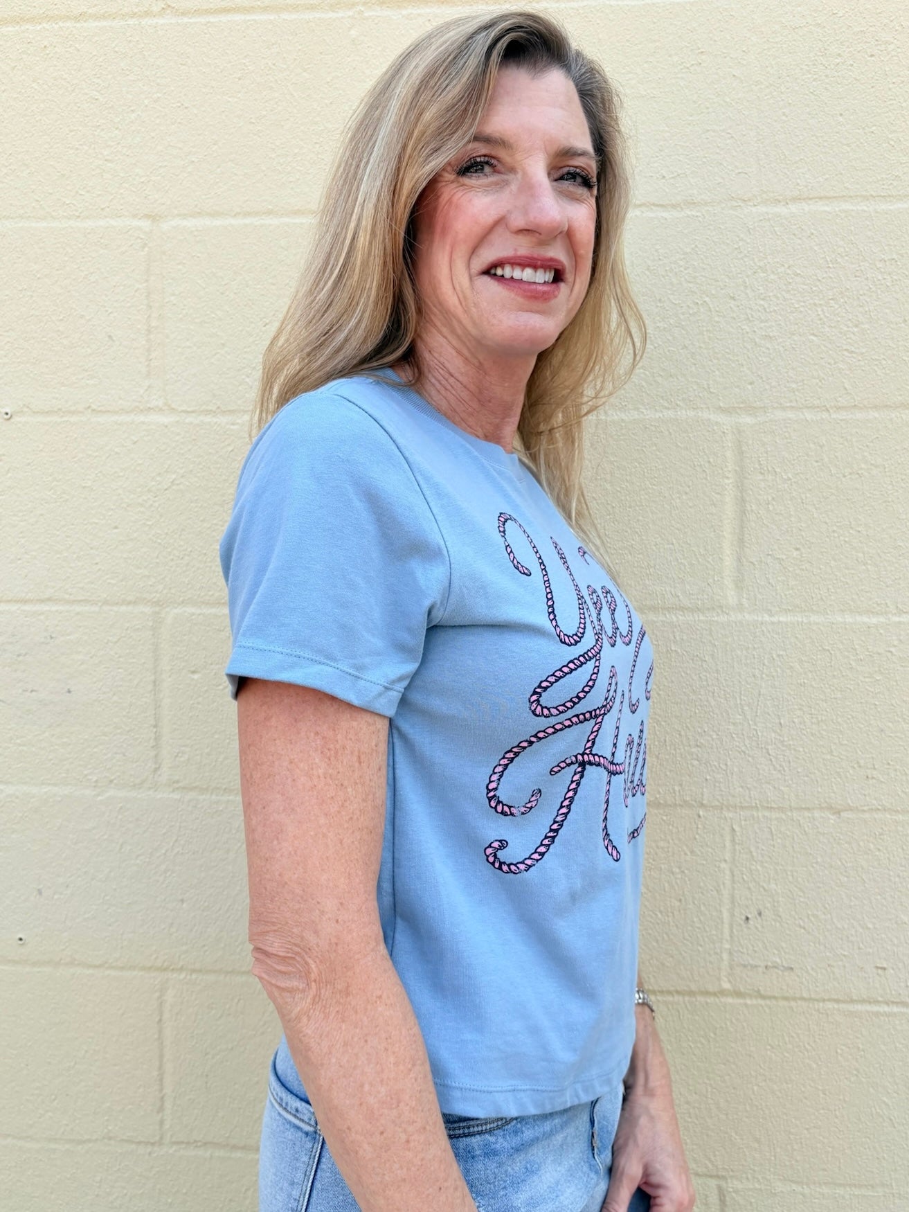 Yeehaw crop tee, western graphic top, mid-length crop shirt, pink rope graphic, southern chic apparel, cowgirl style, soft graphic tee, women's western fashion.
at ooh la la! in Grapevine TX 76051