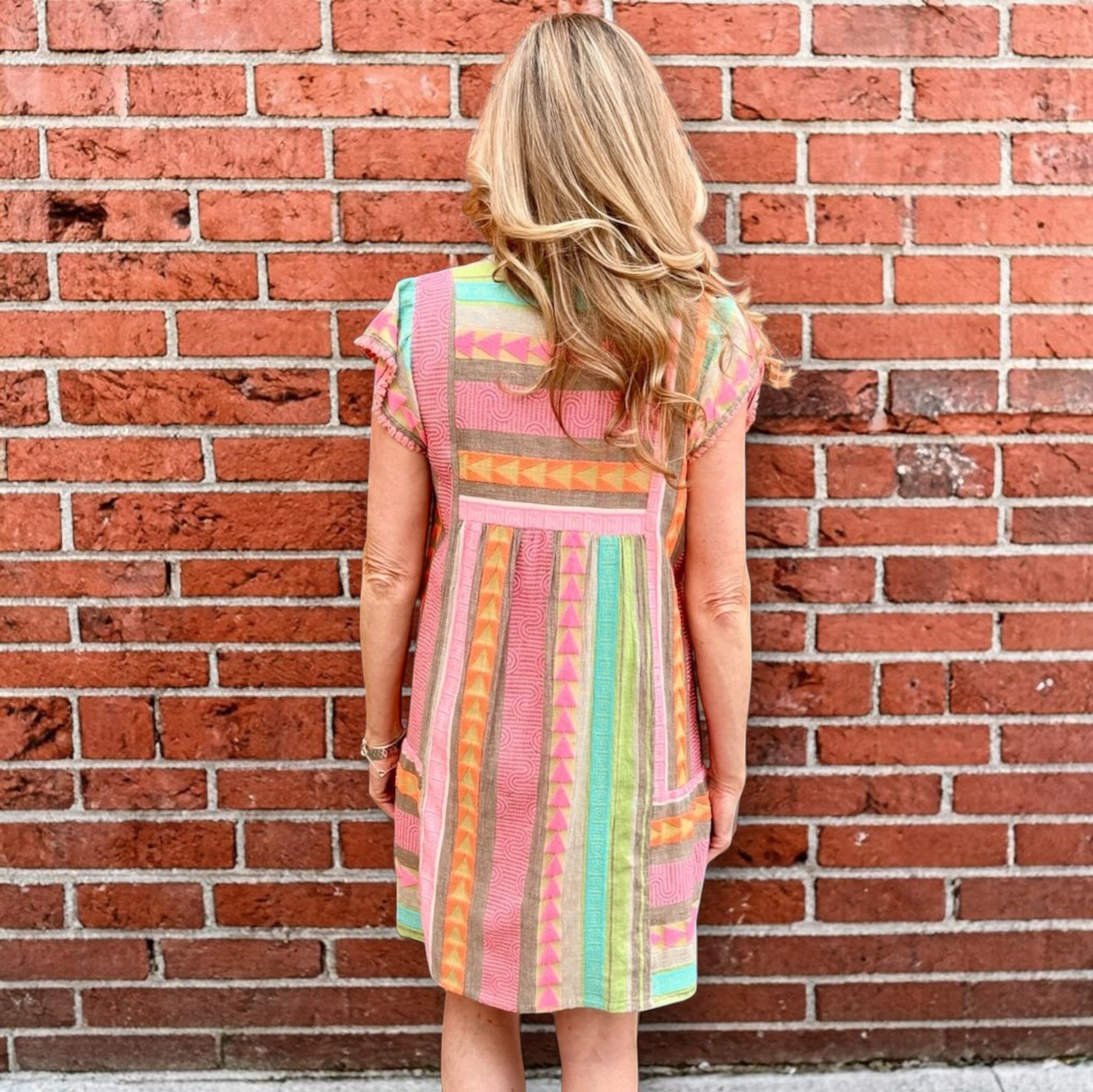 Boho beach dress, neon summer dress, flutter sleeve mini, geometric print dress, tassel trim dress, resort wear for women, cotton v-neck dress, vacation outfits, colorful sun dress. at ooh la la! in Grapevine TX 76051
