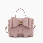 Vegan leather crossbody in blush, bow satchel bag, designer vegan handbags, women's spring purses, bow front handbag, gold hardware crossbody, eco-friendly satchel, Zoey bag.
ooh la la! in Grapevine TX 76051