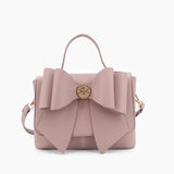 Vegan leather crossbody in blush, bow satchel bag, designer vegan handbags, women's spring purses, bow front handbag, gold hardware crossbody, eco-friendly satchel, Zoey bag.
ooh la la! in Grapevine TX 76051