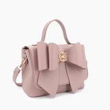 Vegan leather crossbody in blush, bow satchel bag, designer vegan handbags, women's spring purses, bow front handbag, gold hardware crossbody, eco-friendly satchel, Zoey bag.
ooh la la! in Grapevine TX 76051
