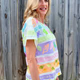 Queen of Sparkles, seashell sequin tee, pastel colorblock top, coastal vacation outfit, designer beach wear, sequin shell shirt, luxury summer fashion. at ooh la la! in Grapevine TX 76051