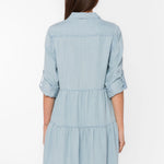Bree Dress, Tencel lyocell dress, tiered mini dress, denim shirt dress, sustainable fashion, eco-friendly women's clothing, light blue chambray dress, tiered dress with pockets. at ooh la la! in Grapevine TX 76051