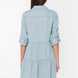 Bree Dress, Tencel lyocell dress, tiered mini dress, denim shirt dress, sustainable fashion, eco-friendly women's clothing, light blue chambray dress, tiered dress with pockets. at ooh la la! in Grapevine TX 76051