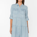 Bree Dress, Tencel lyocell dress, tiered mini dress, denim shirt dress, sustainable fashion, eco-friendly women's clothing, light blue chambray dress, tiered dress with pockets. at ooh la la! in Grapevine TX 76051
