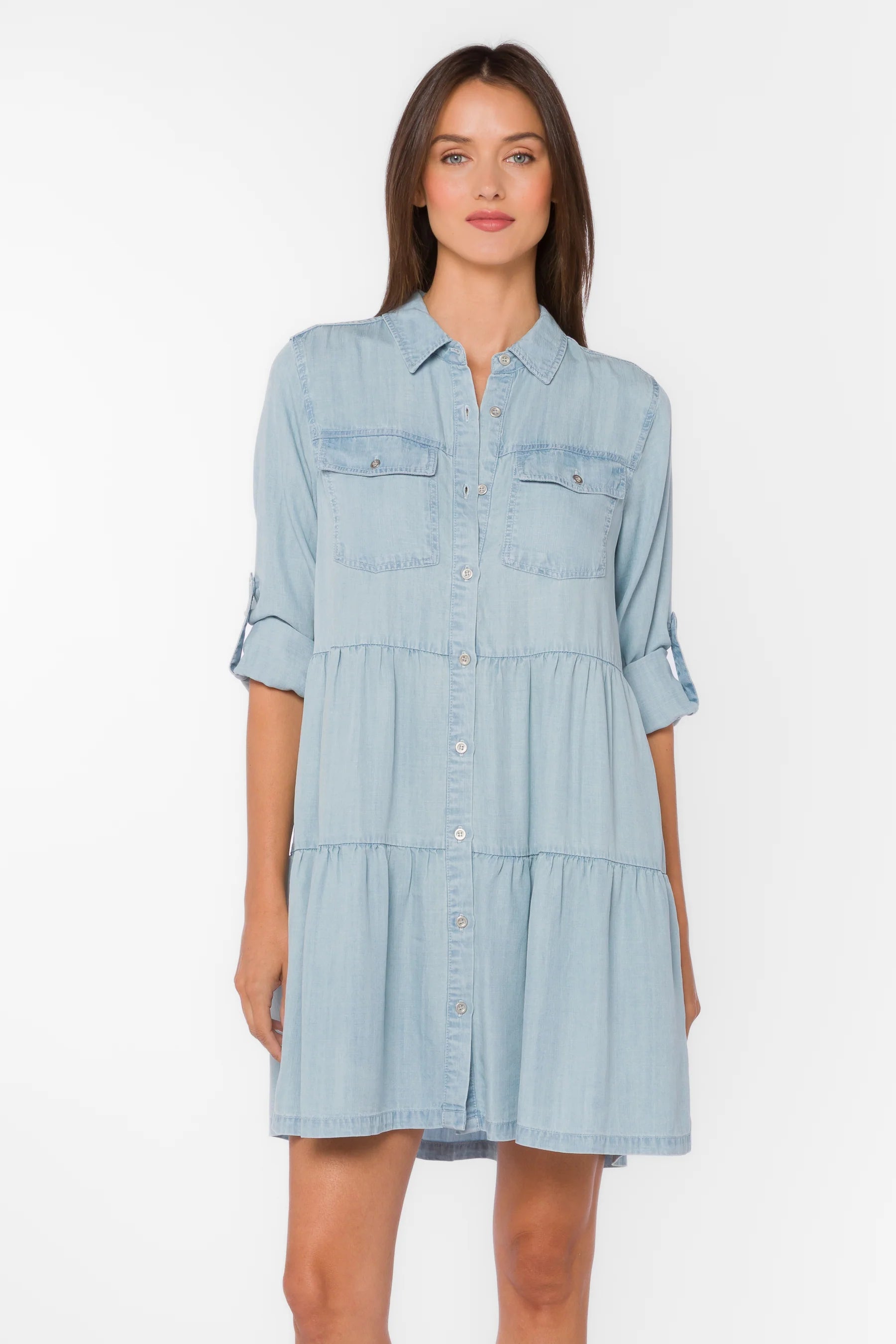 Bree Dress, Tencel lyocell dress, tiered mini dress, denim shirt dress, sustainable fashion, eco-friendly women's clothing, light blue chambray dress, tiered dress with pockets. at ooh la la! in Grapevine TX 76051
