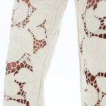 off white floral cutout jeans, embroidered straight leg pants, women's cream denim, high rise relaxed jeans, boho lace pants, luxury embroidered denim, off white floral trousers at ooh la la in Grapevine TX 76051