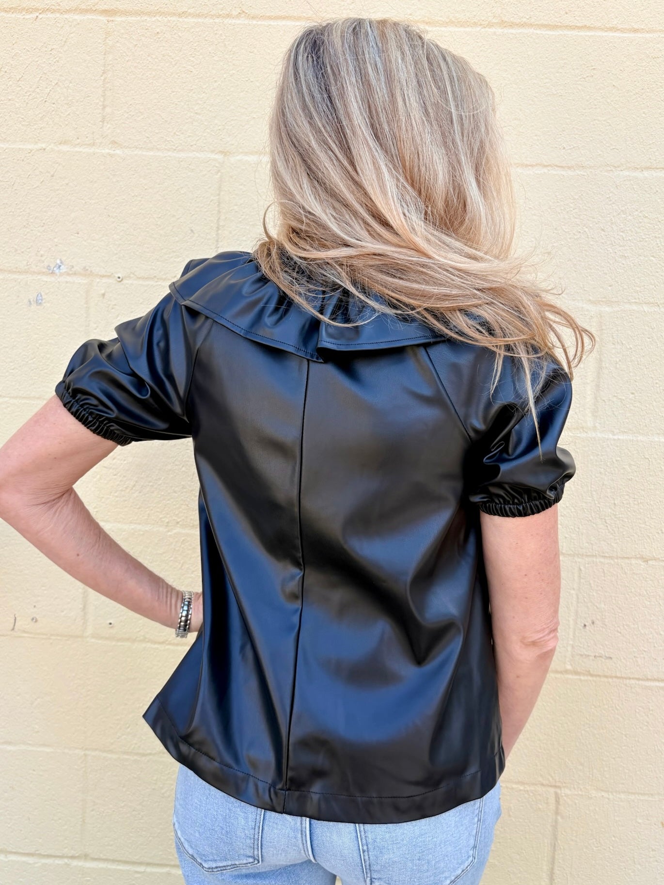 Ruffle V Neck Faux Leather Top in black at ooh la la in Grapevine TX 76051