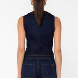 Back view of dark navy denim vest with brown leather trim and matching wide-leg jeans