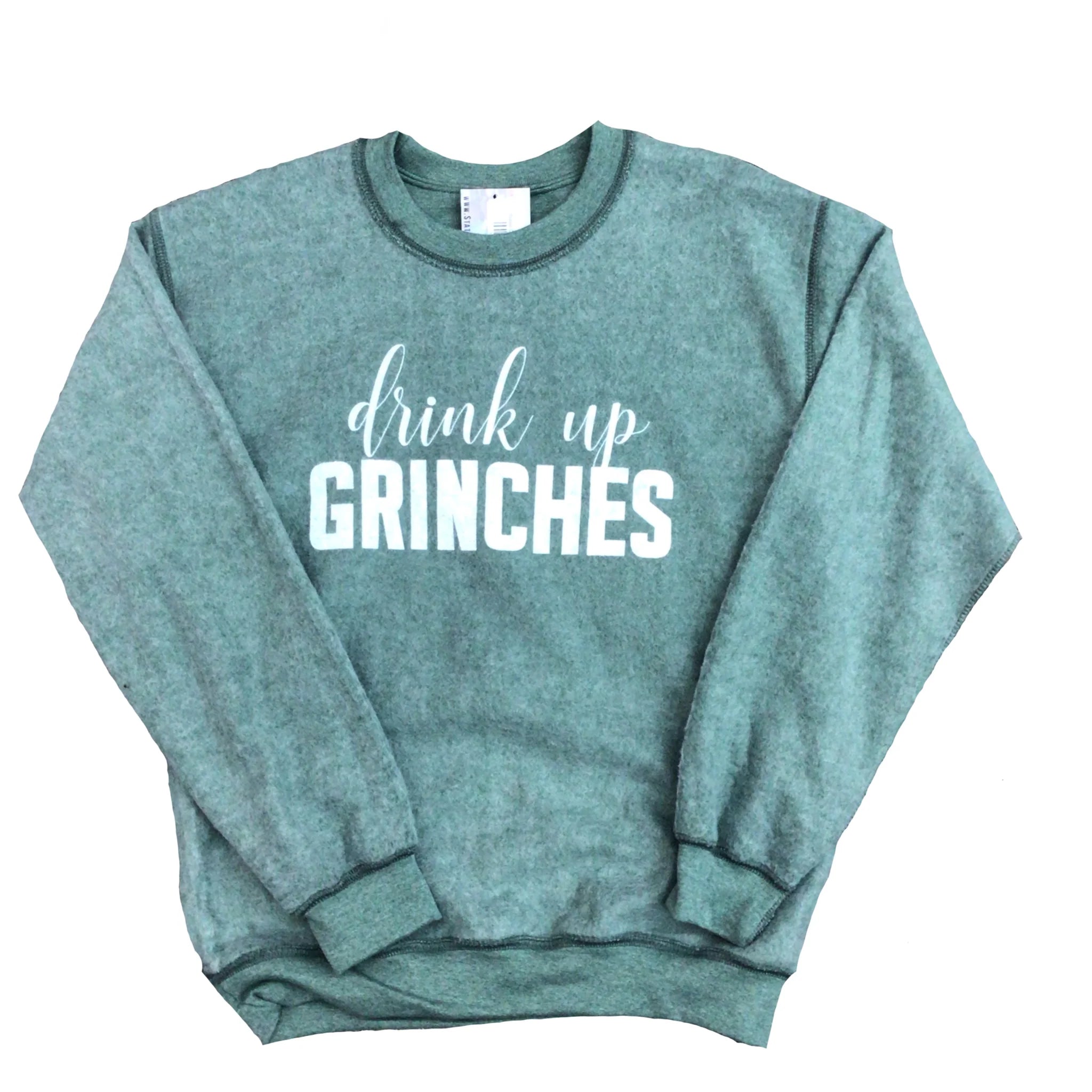 Washed sage green crewneck sweatshirt featuring the white graphic text "drink up" in a script font above the bold block text "GRINCHES." The sweatshirt has a faded, pigment-dyed finish.