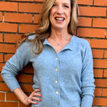 Light Blue soft knit cardigan, women's crewneck cardigan, button down sweater, pastel knitwear, lightweight layering piece, classic women's sweater, pearl button cardigan, spring knitwear staples.
at ooh la la in Grapevine TX 76051