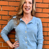 Light Blue soft knit cardigan, women's crewneck cardigan, button down sweater, pastel knitwear, lightweight layering piece, classic women's sweater, pearl button cardigan, spring knitwear staples.
at ooh la la in Grapevine TX 76051