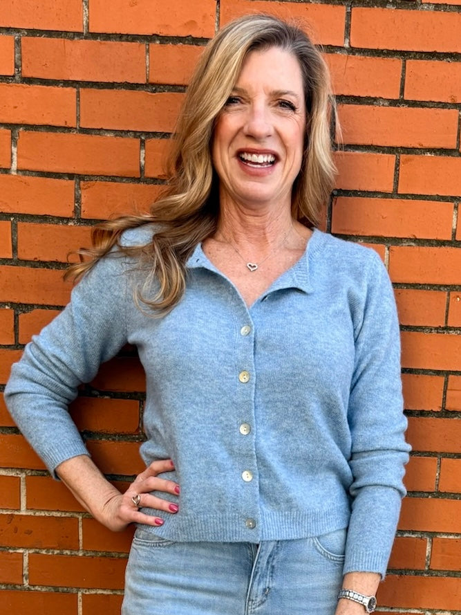 Light Blue soft knit cardigan, women's crewneck cardigan, button down sweater, pastel knitwear, lightweight layering piece, classic women's sweater, pearl button cardigan, spring knitwear staples.
at ooh la la in Grapevine TX 76051