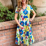 Dress Addict Jazy, organic cotton midi dress, multi color floral dress with pockets, sustainable summer dress, bias cut v-neck dress, women's tiered floral midi, travel-friendly crinkle dress. at ooh la la! in Grapevine TX 76051