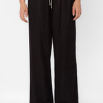 Black satin wide-leg drawstring pants with cream tie on female model