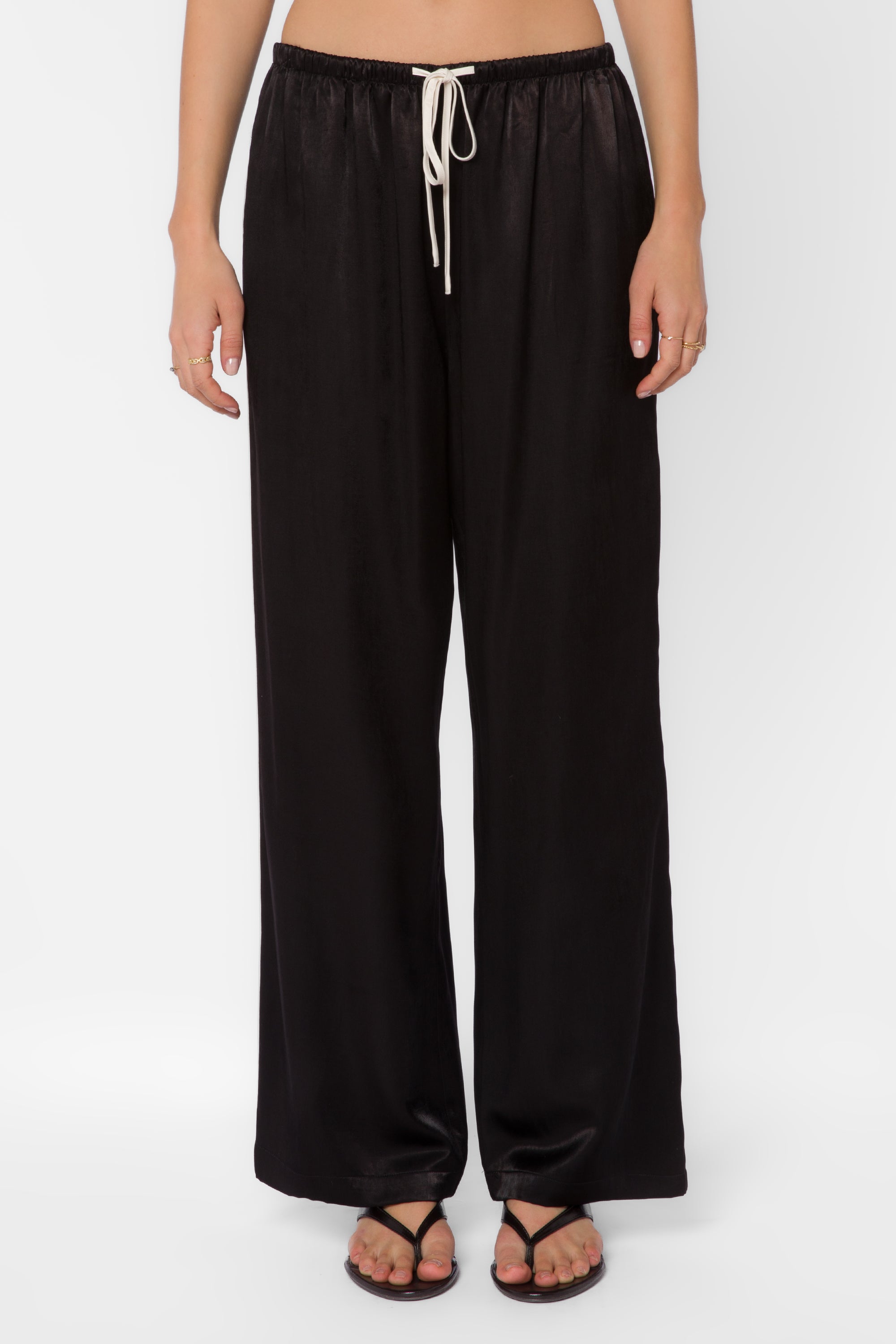 Black satin wide-leg drawstring pants with cream tie on female model